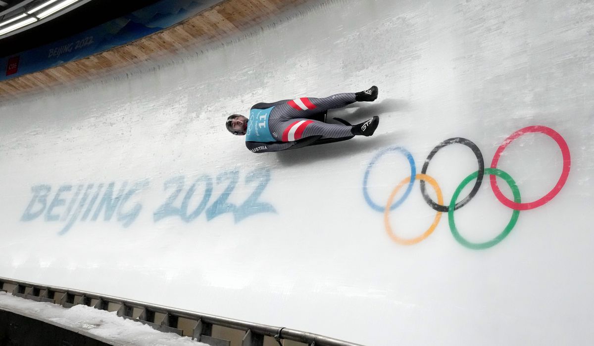 Beijing Winter Olympics begin under a cloud as politics, pandemic take center stage